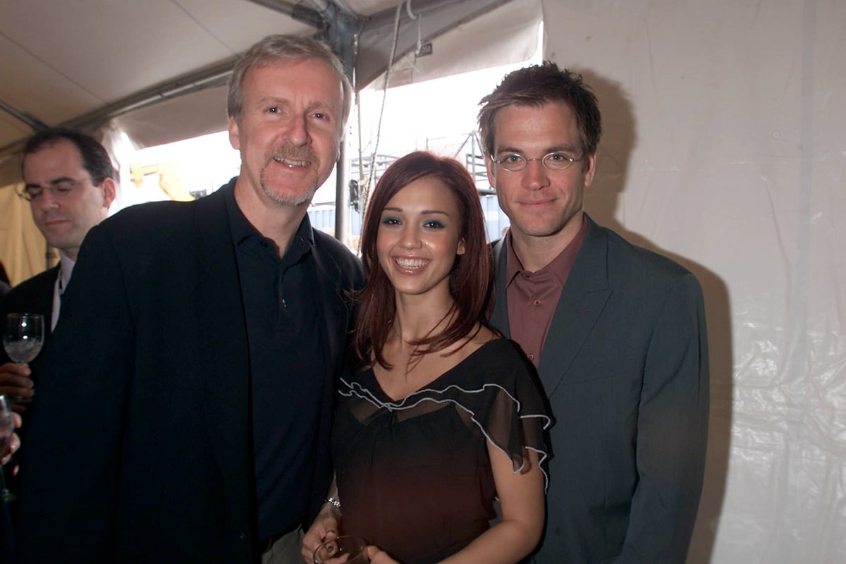 James Cameron, Jessica Alba, and Michael Weatherly standing next to each other.