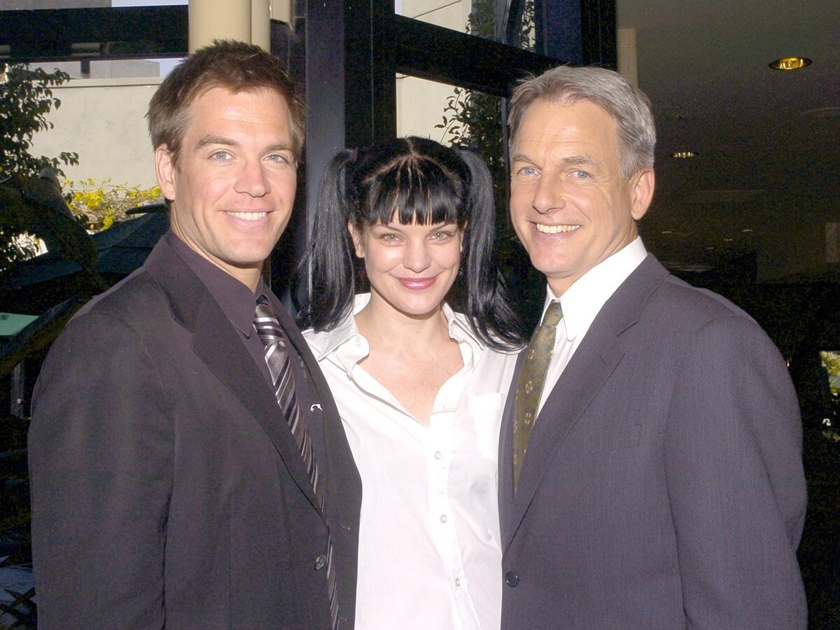 Michael Weatherly and Pauley Perrette posing alongside Mark Harmon.