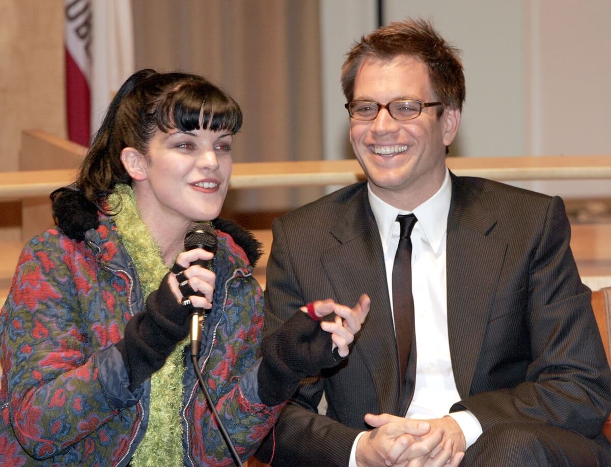 Michael Weatherly smiling next to Pauley Perrette.