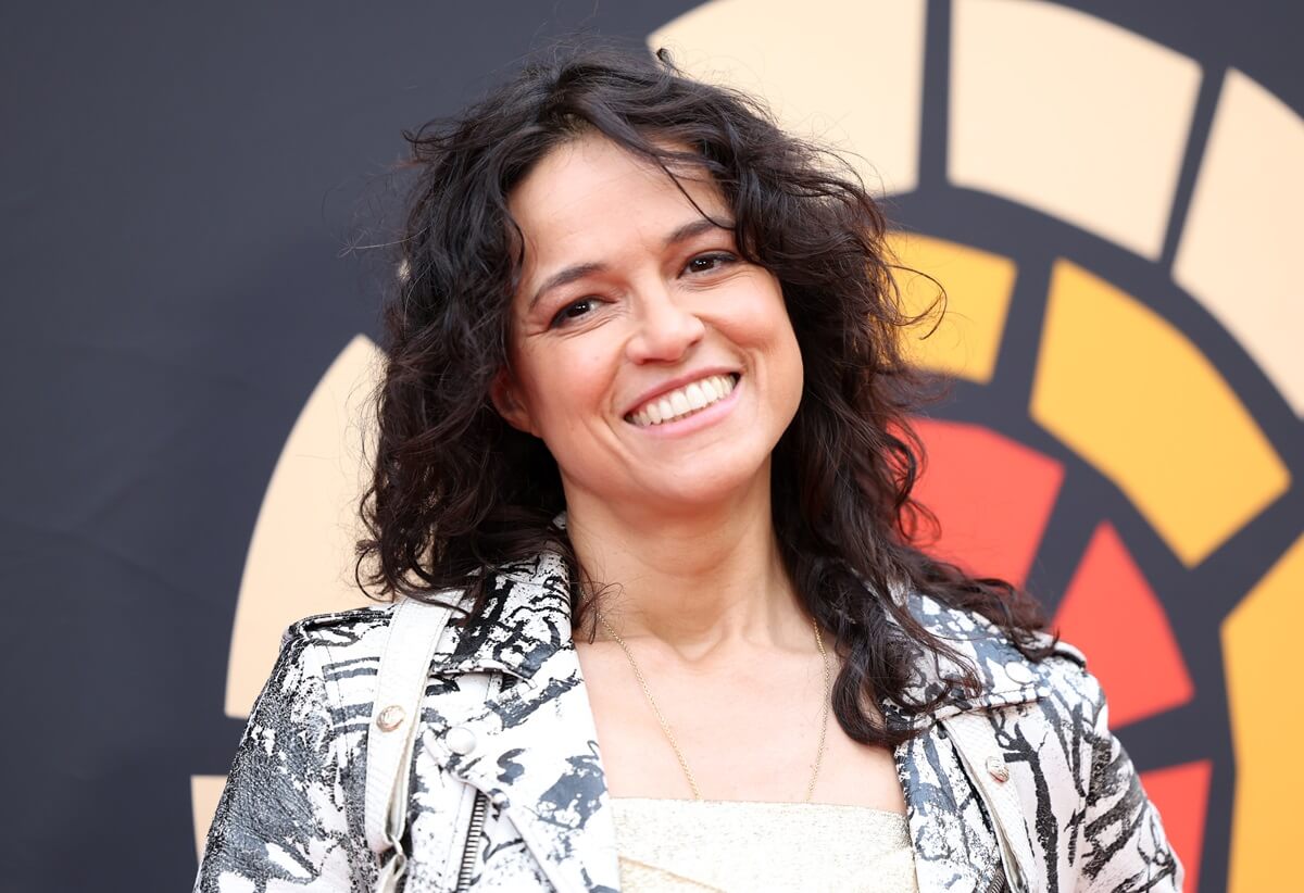 Michelle Rodriguez posing in a silver outfit at the Charlize Theron Africa Outreach Project 2023 Block Party at Universal Studios.