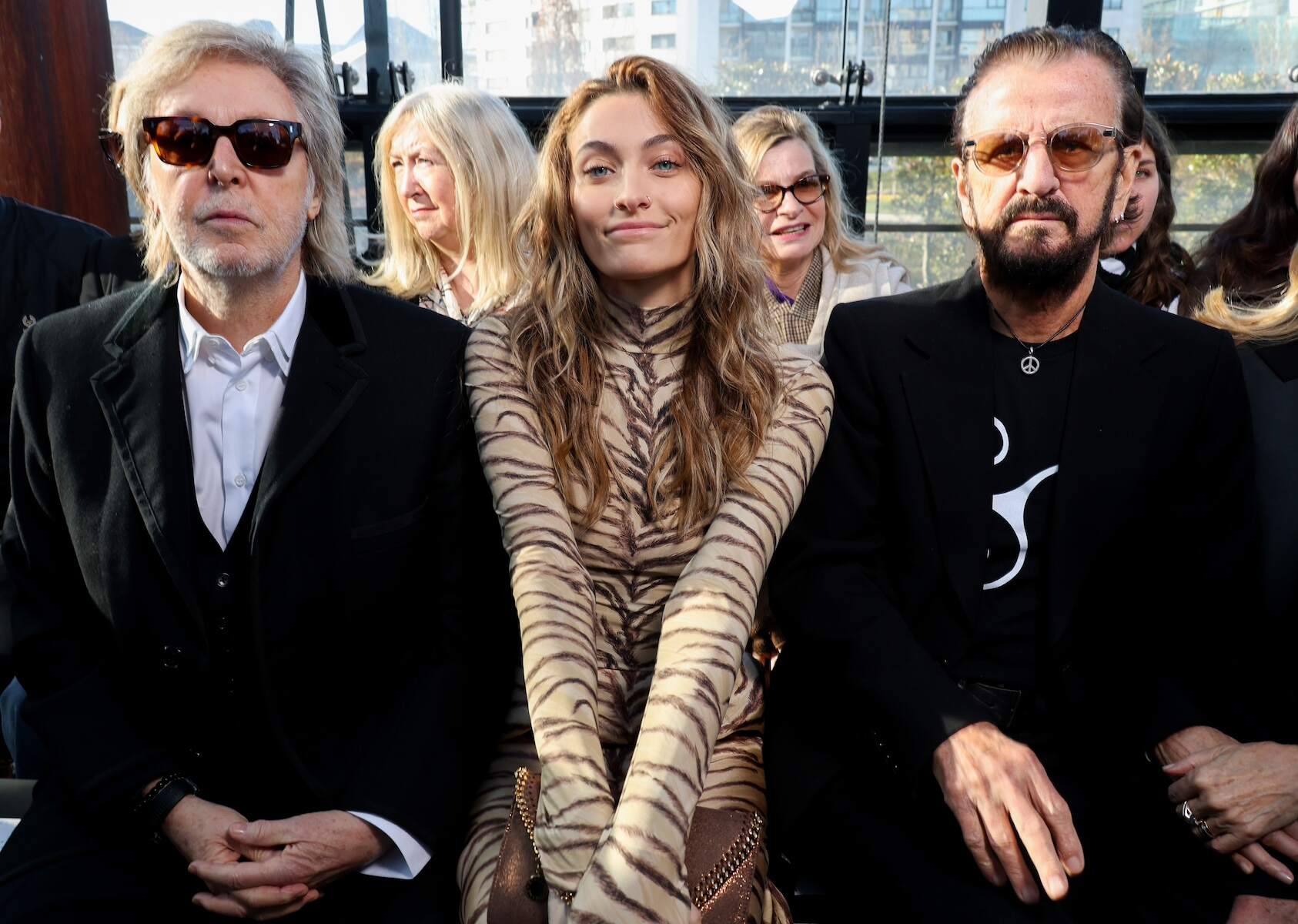 Paris Fashion Show attendees Sir Paul McCartney, Paris Michael Katherine Jackson, and Sir Ringo Starr sit front row together