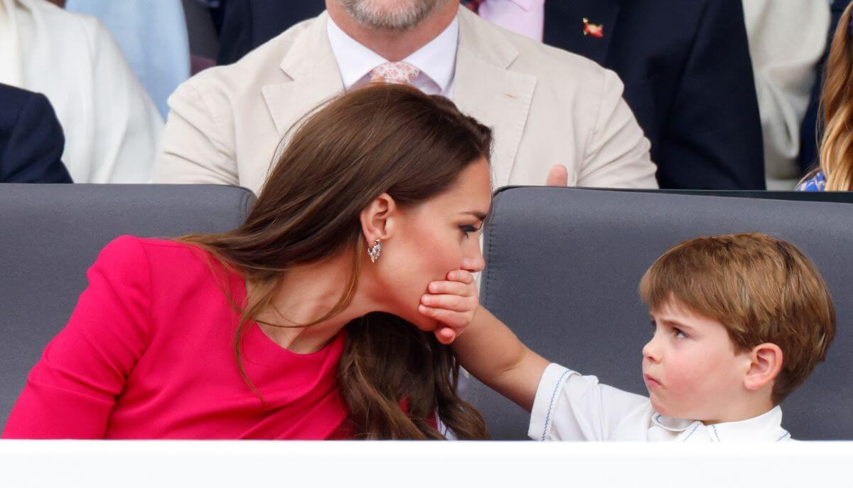 Prince Louis covers his mother Kate Middleton's mouth with his hand as they attend the Platinum Pageant