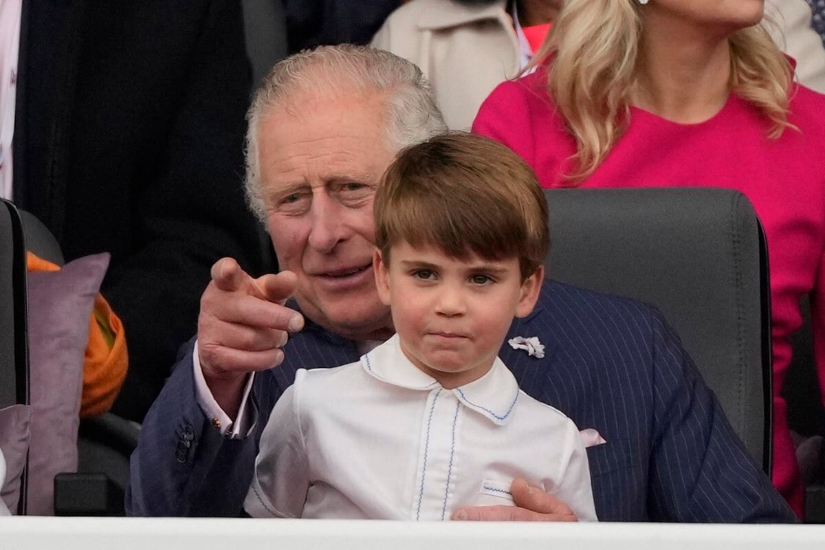 Prince Louis sitting on his grandfather King Charles' knee during the Platinum Pageant in London