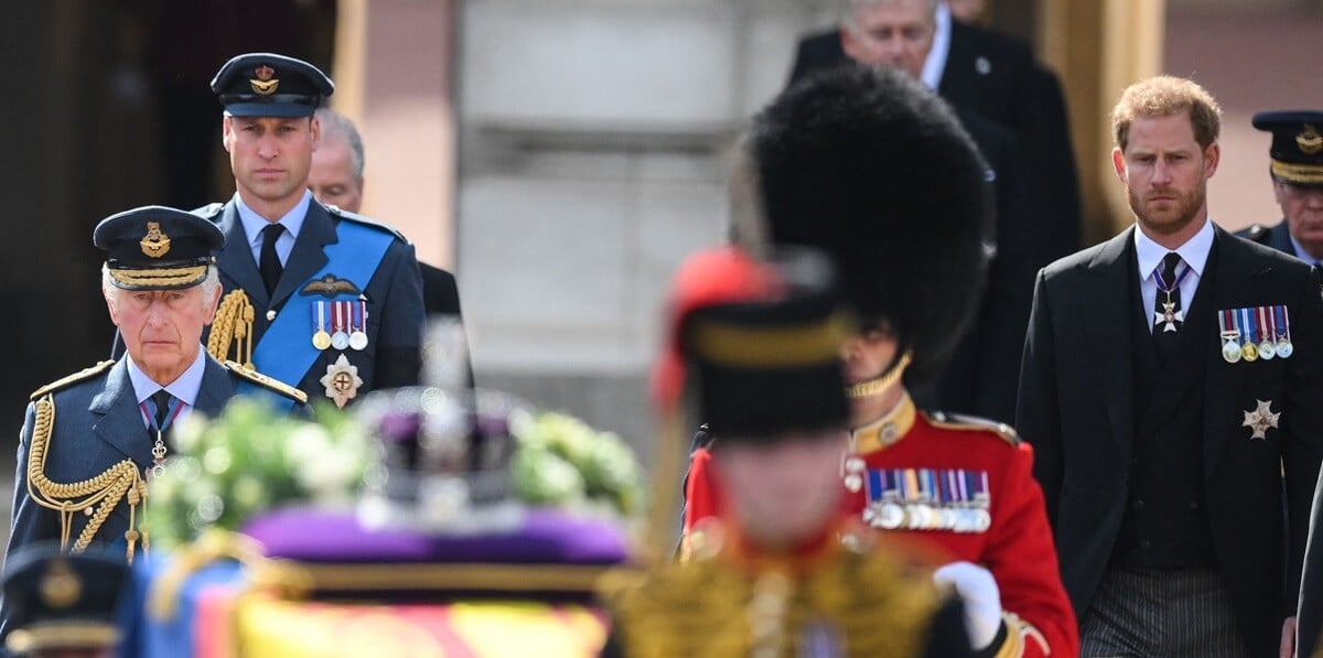 Prince William, Prince Harry, and King Charles III walk behind the coffin of Queen Elizabeth II