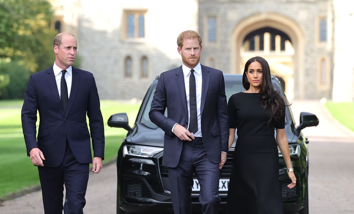 Prince William, Prince Harry, and Meghan Markle arrive to view tributes left at the gates of Windsor Castle to Queen Elizabeth II