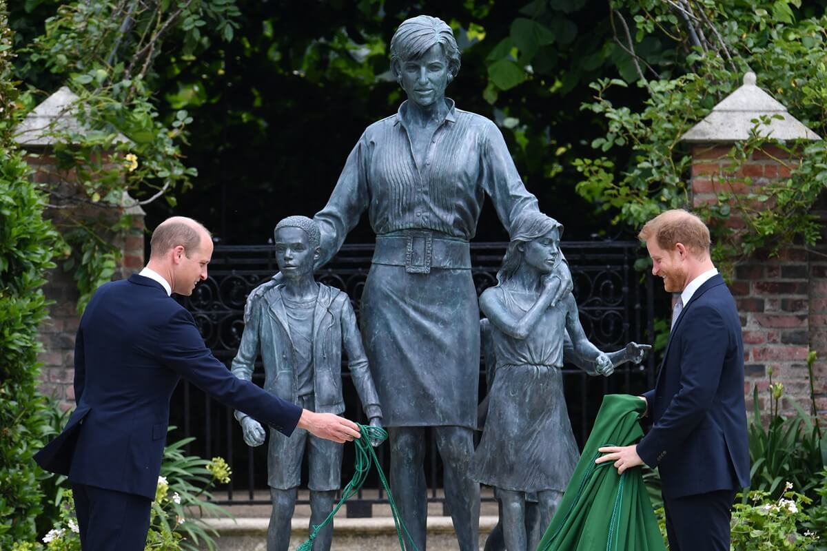 Prince William and Prince Harry unveil a statue they commissioned of their mother Princess Diana in the Sunken Garden at Kensington Palace
