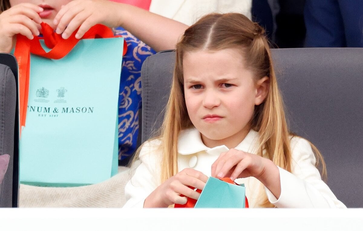 Princess Charlotte opening her Fortnum & Mason gift bag during the Platinum Pageant on The Mall