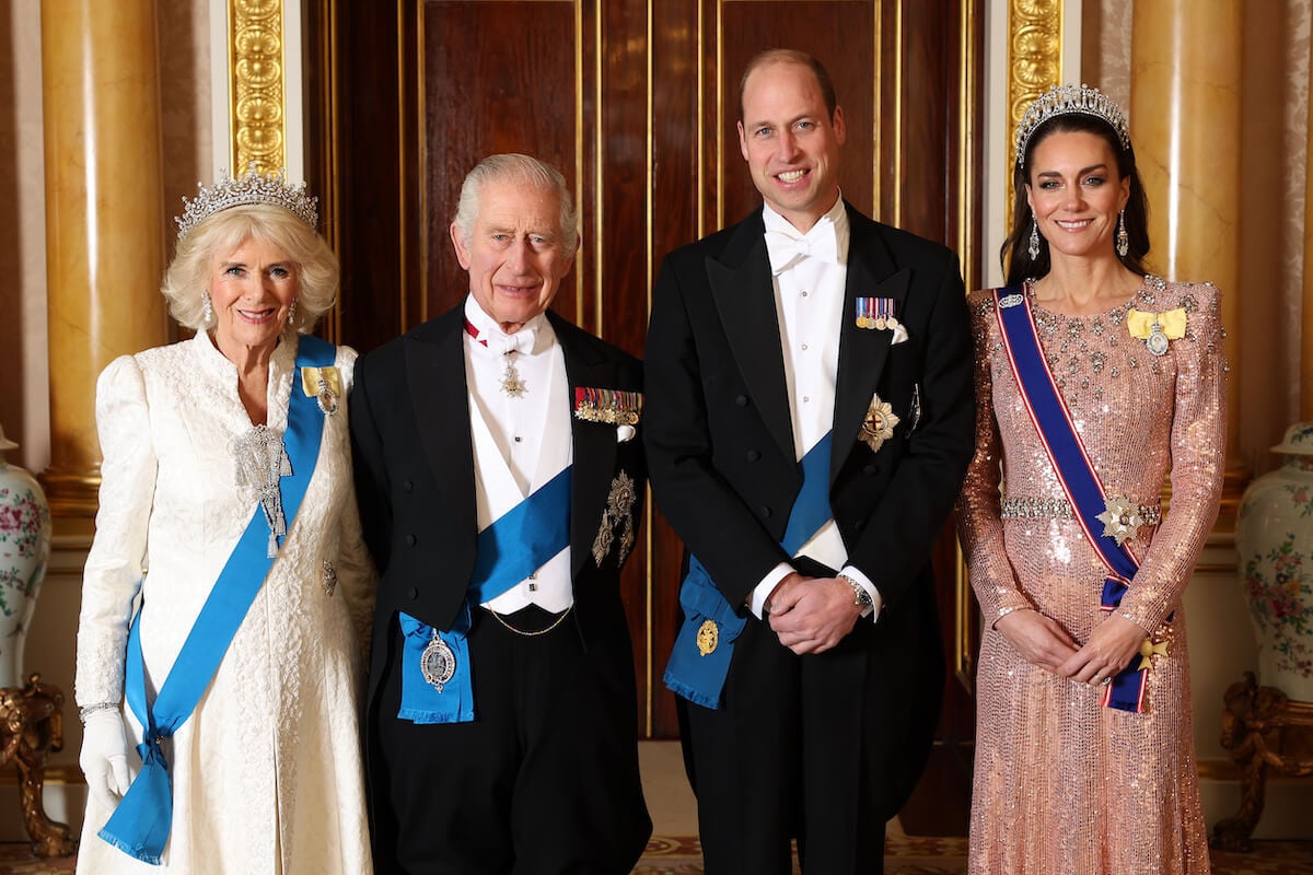 Queen Camilla, King Charles, Prince William, and Kate Middleton, British royals who are off to a 'gloomy' start to 2024, smile