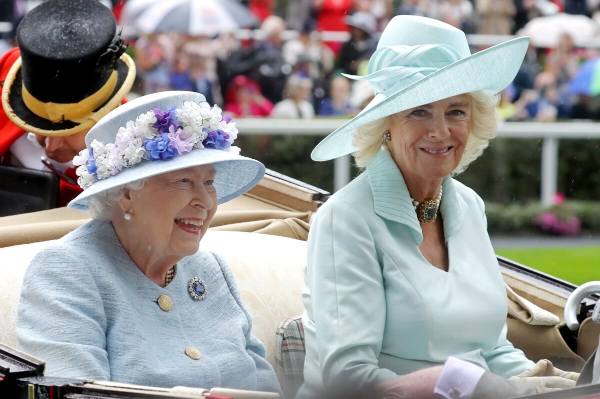 Queen Elizabeth and Camilla Parker Bowles arrive together in a horse carriage at Ascot Racecourse