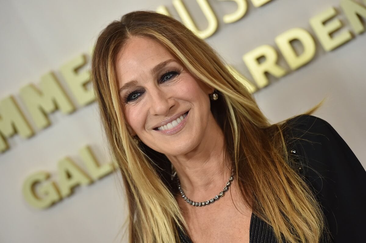 Sarah Jessica Parker smiling while wearing a black blazer.