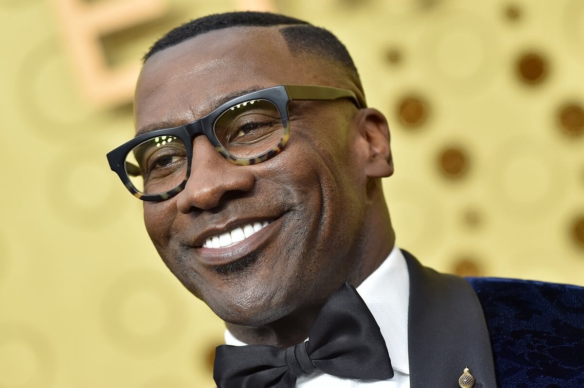 Shannon Sharpe posing in a suit at the 71st Emmy Awards.