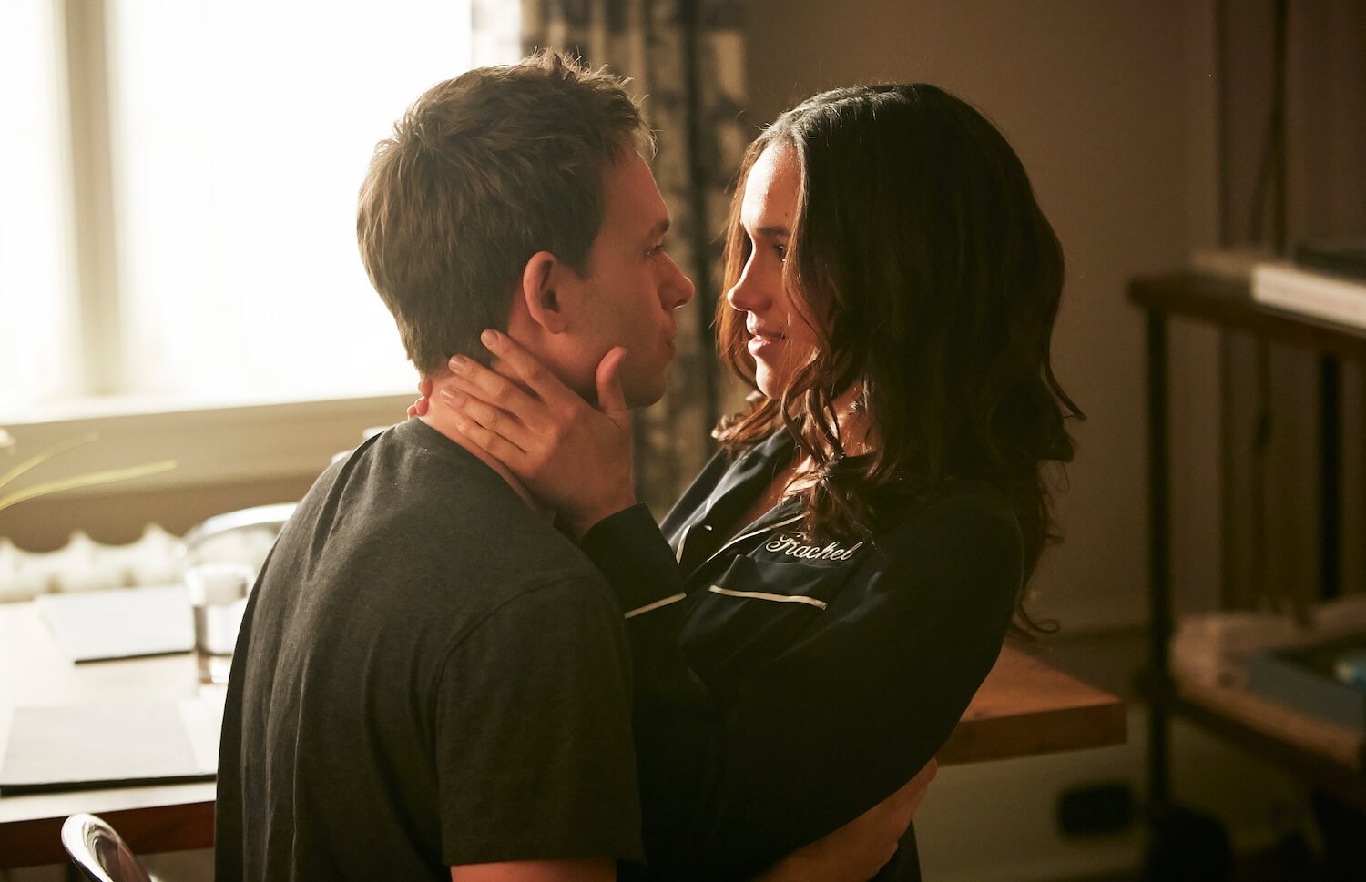 Patrick J. Adams as Michael Ross and Meghan Markle as Rachel Zane in 'Suits.' Michael and Rachel are embracing each other and looking into each other's eyes.