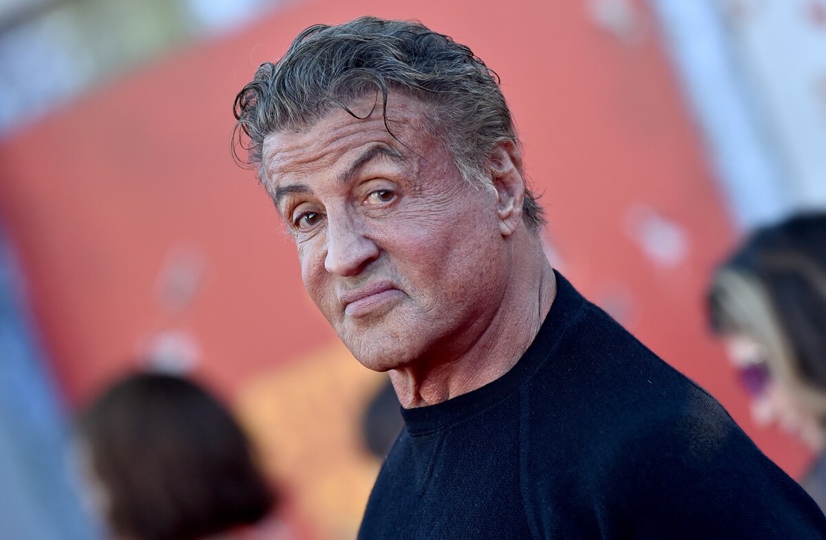 Sylvester Stallone posing in a black shirt at 'The Suicide Squad' premiere.