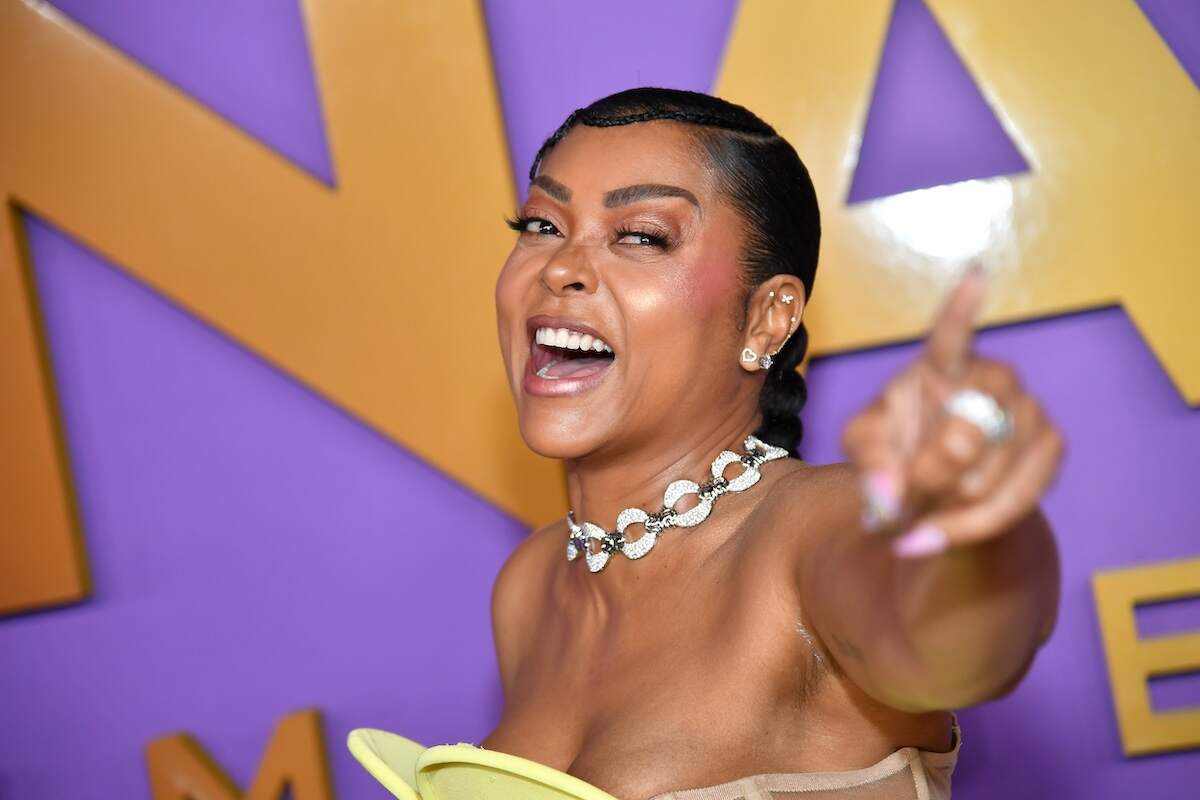 Actor Taraji P. Henson laughs and waves at a photographer on the red carpet at the 55th NAACP Image Awards
