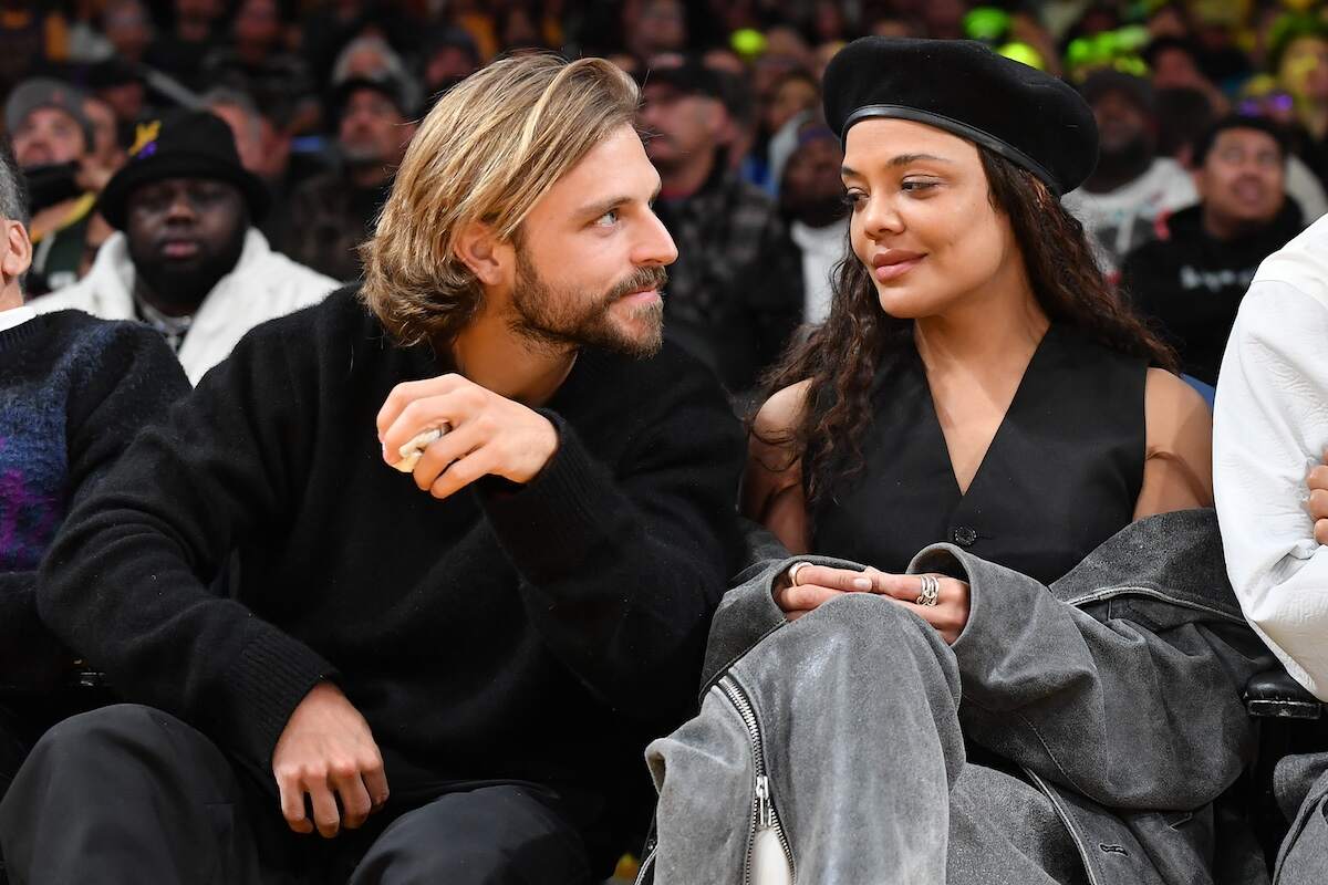 Actor Tessa Thompson and socialite Brandon Green look at each other during a Lakers game