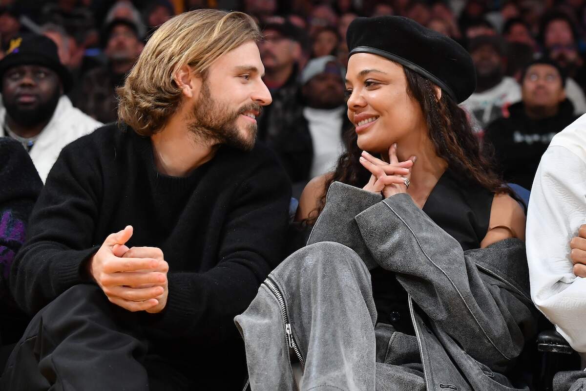 Actor Tessa Thompson and socialite Brandon Green look at each other during a Lakers game