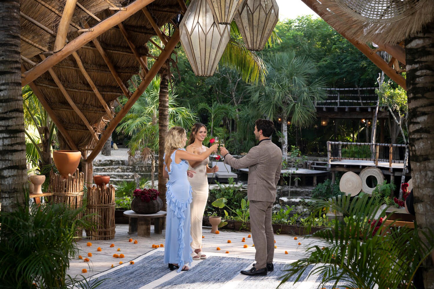 Daisy Kent and Kelsey Anderson toasting with Joey Graziadei after a rose ceremony outdoors in 'The Bachelor' Season 28