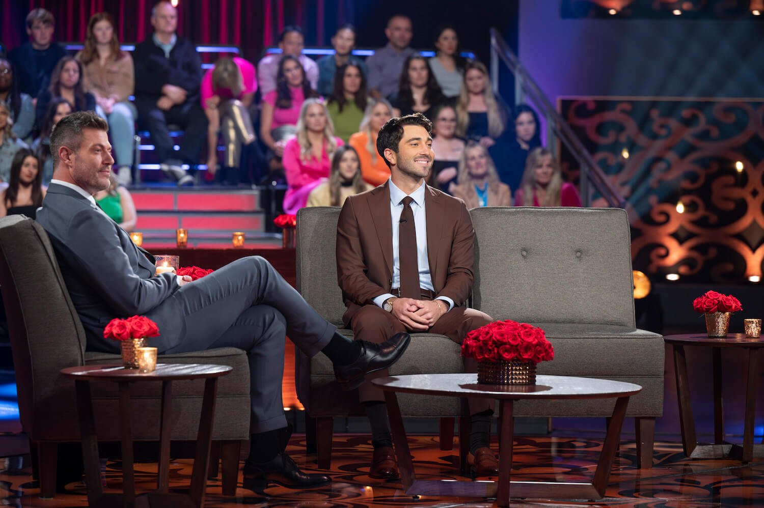 Joey Graziadei sitting on stage with Jesse Palmer during 'The Bachelor' Season 28 Women Tell All