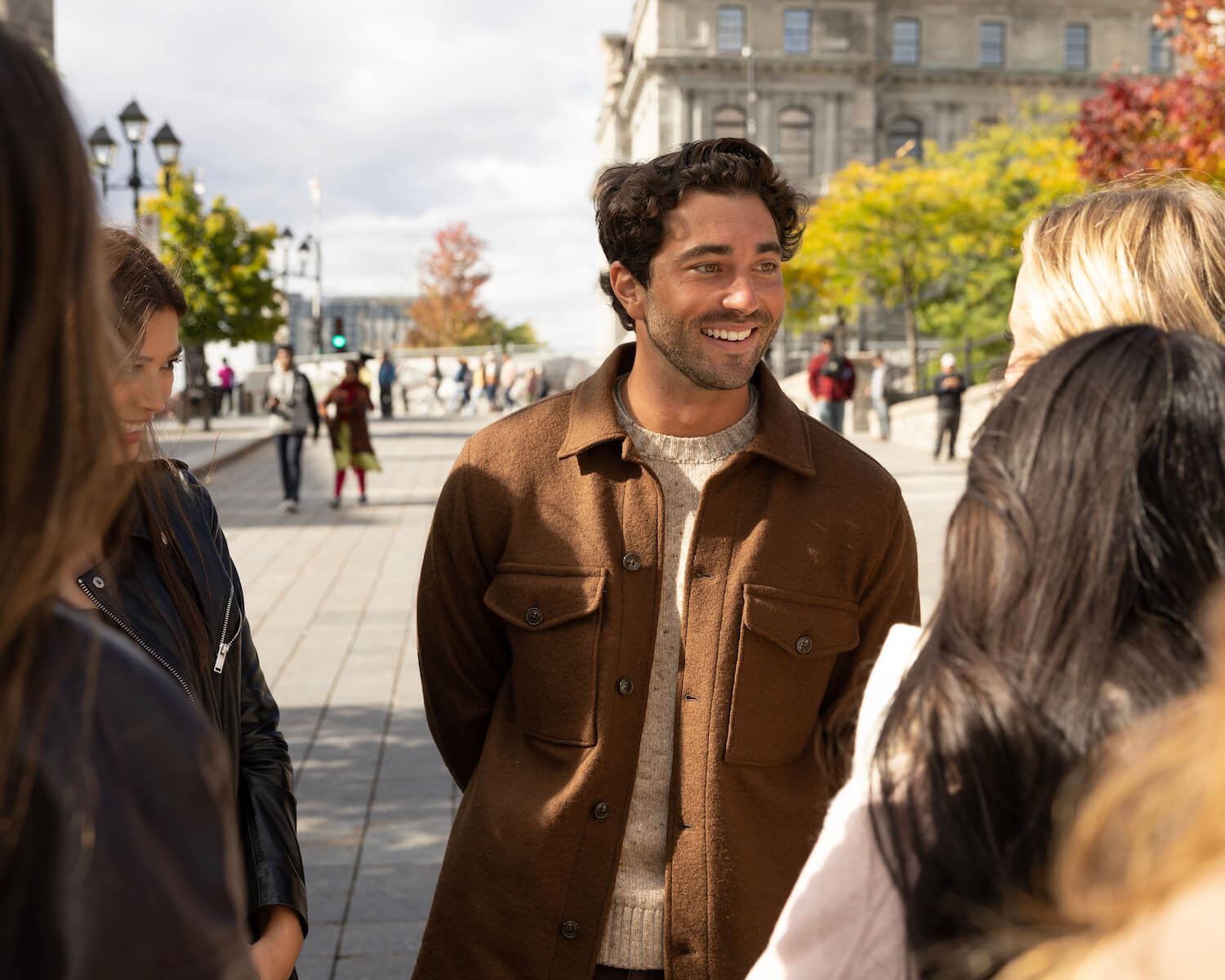 Joey Graziadei talking to the remaining women outdoors before a group date in 'The Bachelor' Season 28