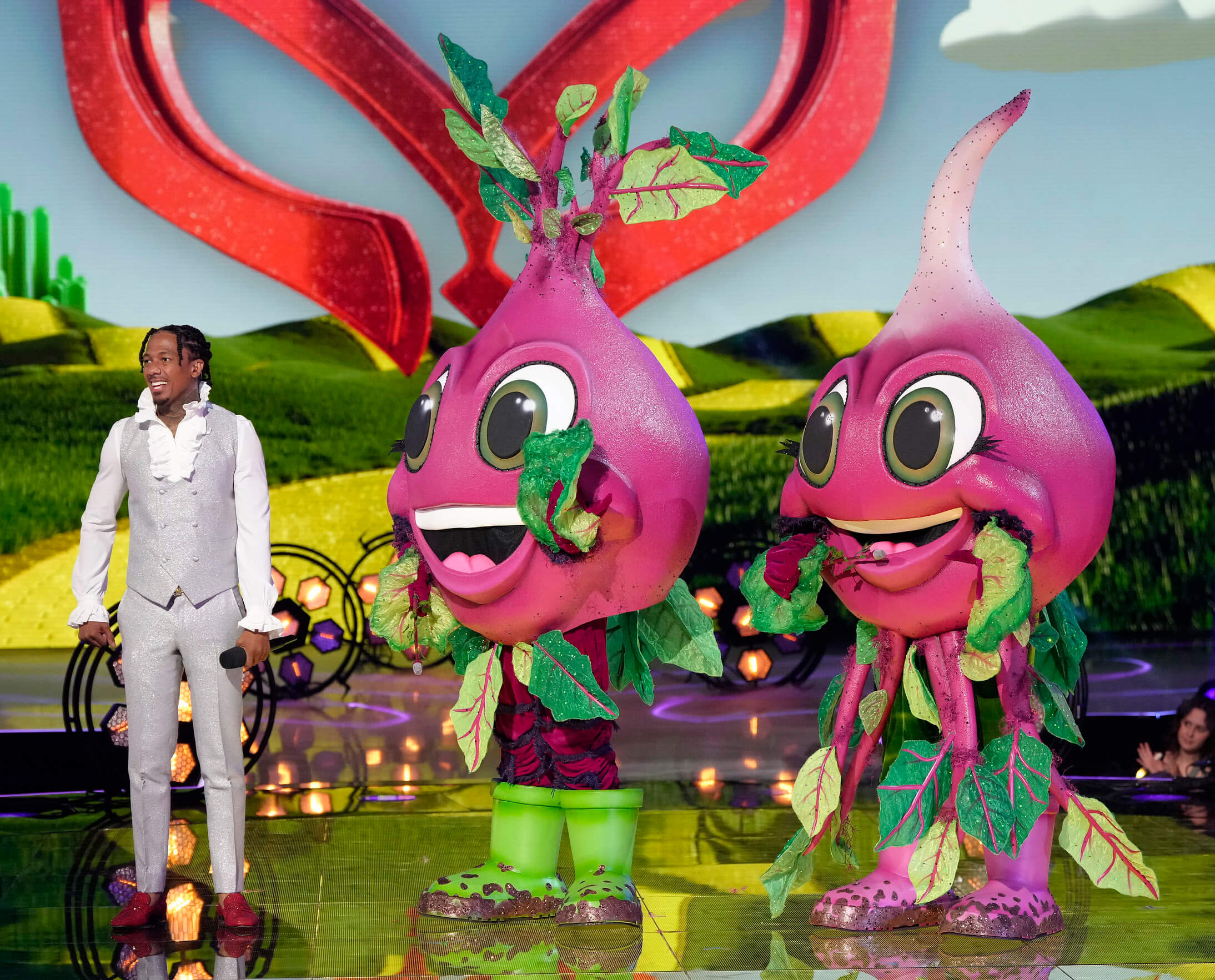 'The Masked Singer' Season 11 Group B costume, the Beets, standing next to Nick Cannon