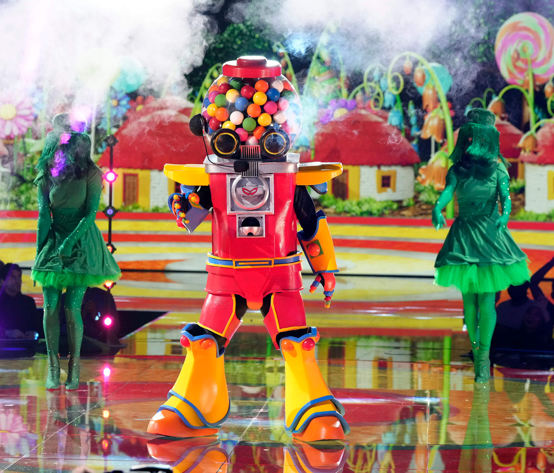 'The Masked Singer' Season 11 singer Gumball on stage with 2 green backup dancers