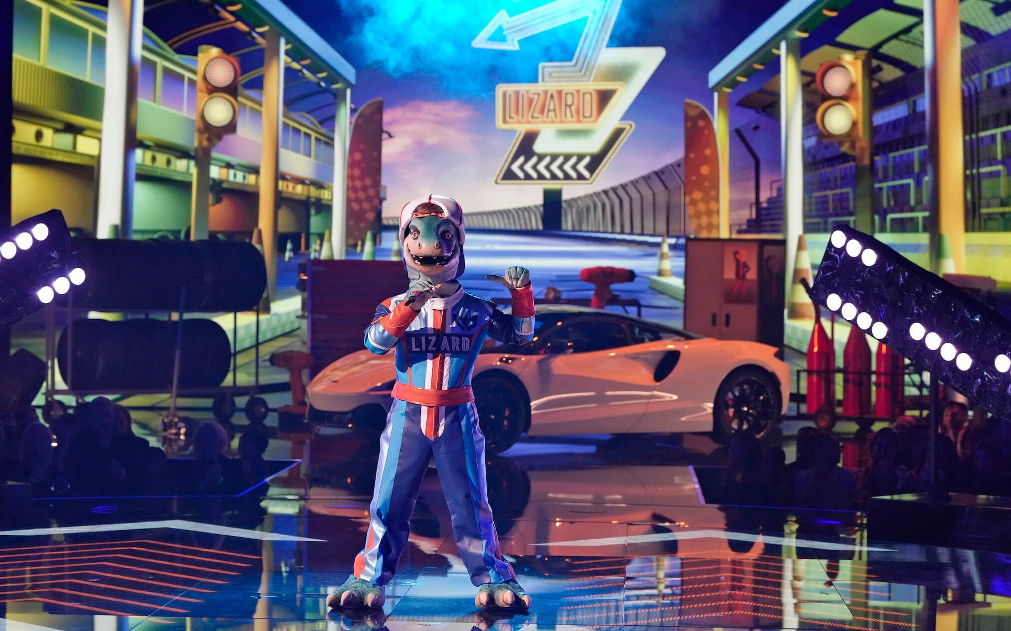 'The Masked Singer' Season 11 Group C mask Lizard on stage in front of a car