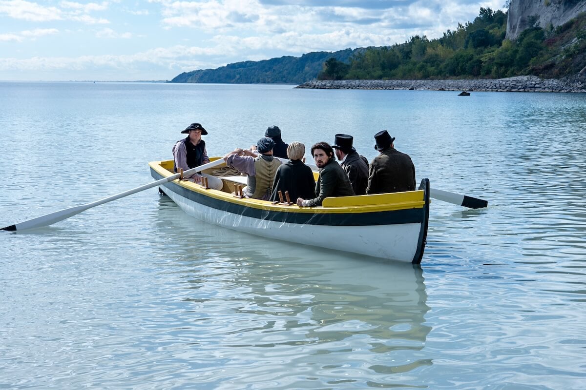 Jacob in a rowboat with other passengers in 'The Way Home'