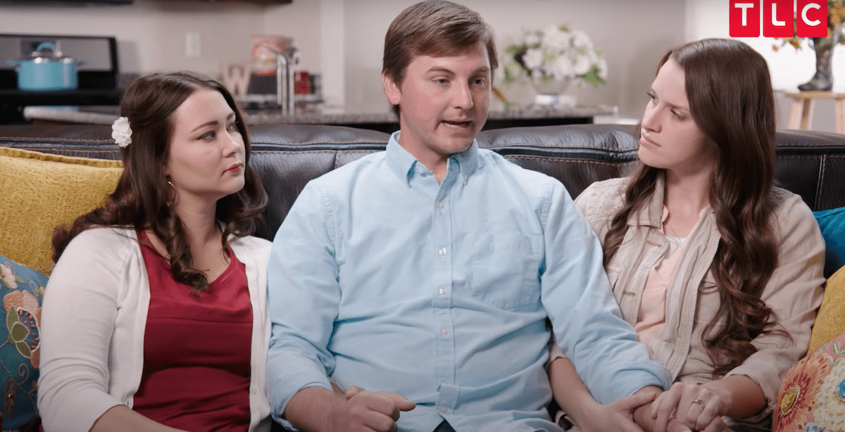 Colton Winder, center, sitting on a couch with his two wives in 'Seeking Sister Wife'