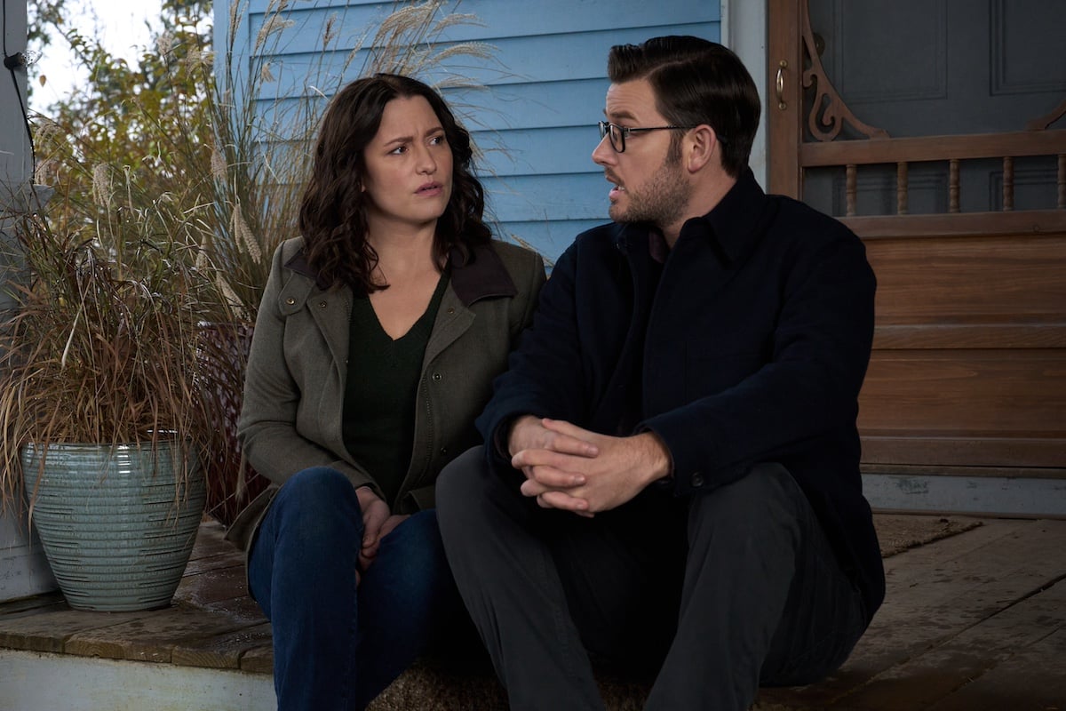 Kat and Elliot sitting on the steps of a house in 'The Way Home' Season 2