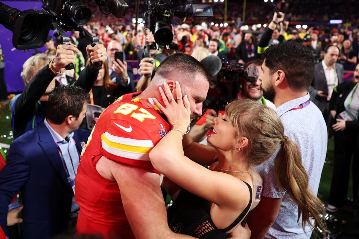 Travis Kelce and Taylor Swift embrace and Taylor Swift embrace after the Kansas City Chiefs win Super Bowl LVIII