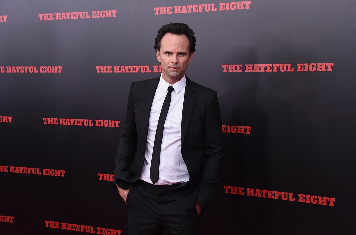 Walton Goggins posing in a suit at the premiere of 'The Hateful Eight'.