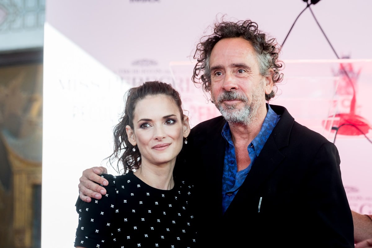 Winona Ryder posing with Tim Burton at the Tim Burton Hand And Footprint Ceremony.