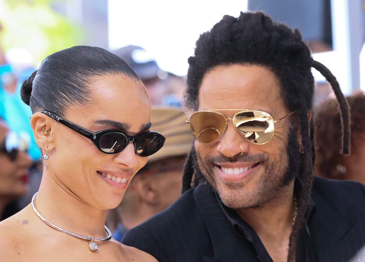 Actor Zoë Kravitz and father Lenny Kravitz smile in the front row during Lenny's Walk of Fame ceremony