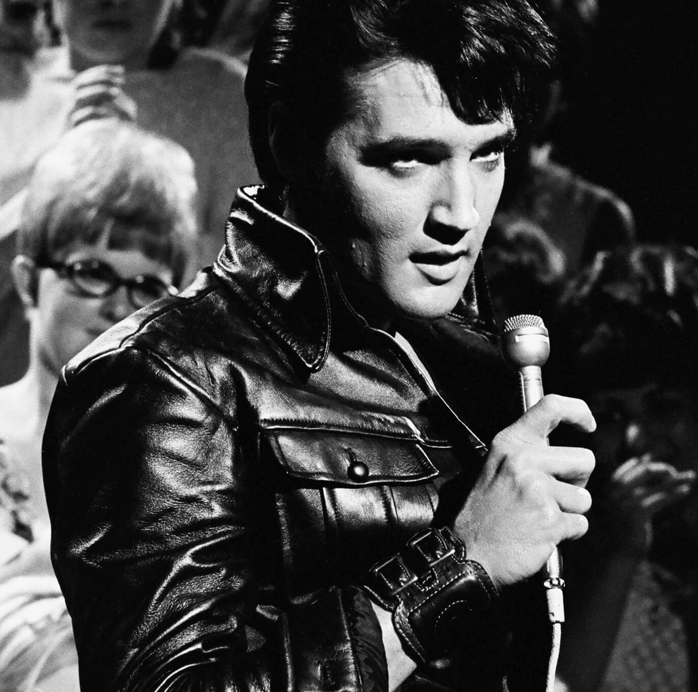 "A Little Less Conversation" singer Elvis Presley with a microphone