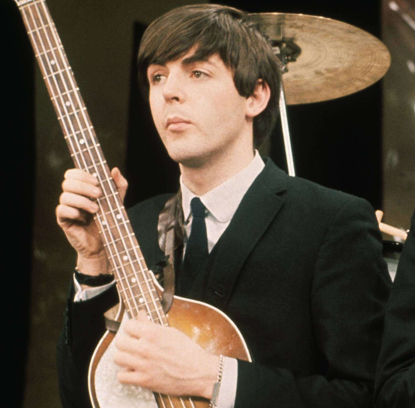 Paul McCartney playing a song on an instrument