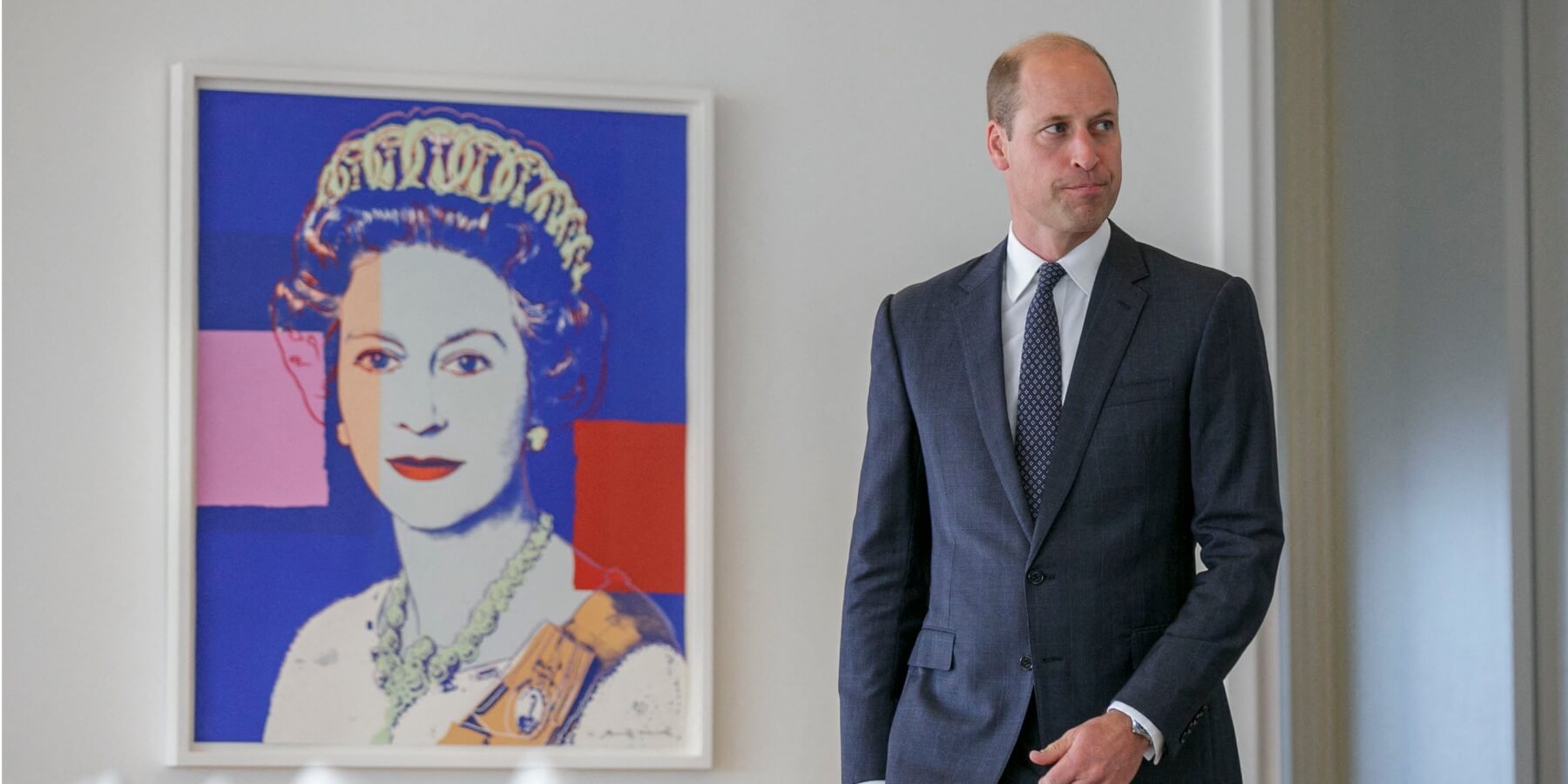 Prince William poses by a print of his grandmother, Queen Elizabeth, in 2023.