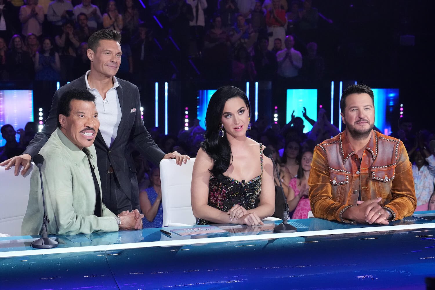 'American Idol' judges Lionel Richie, Katy Perry, and Luke Bryan sitting at the judging table with host Ryan Seacrest behind them