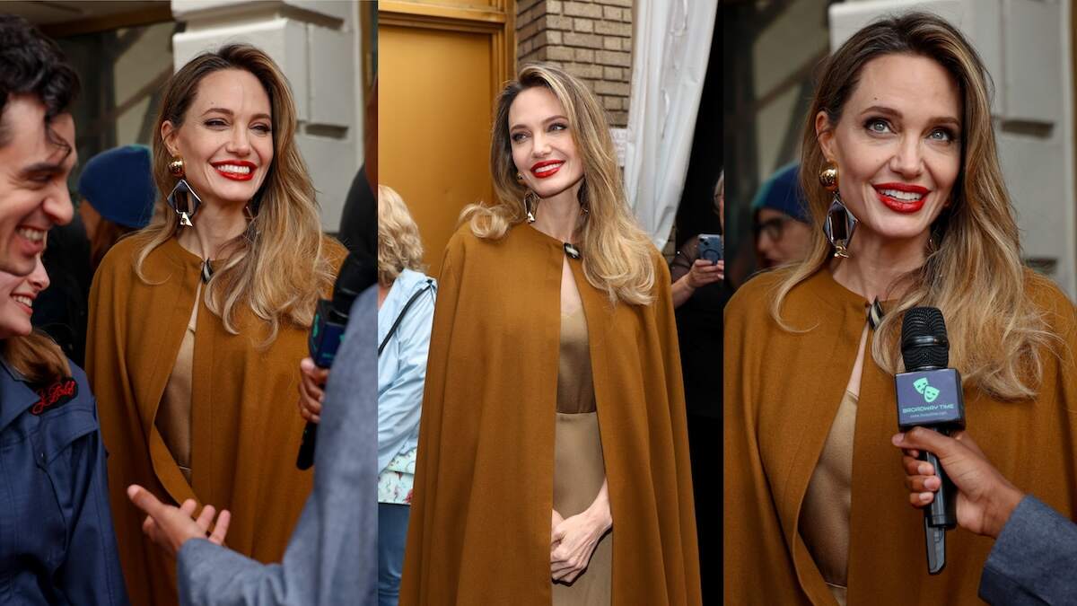 Actor Angelina Jolie walks the red carpet in red lipstick and an ochre cape