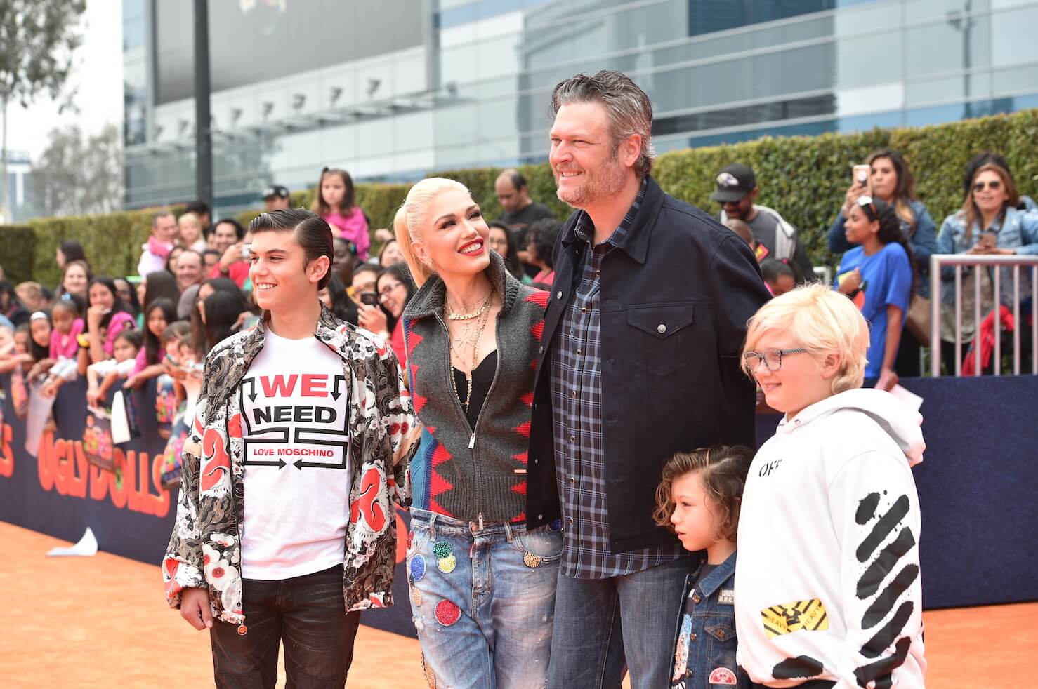 Gwen Stefani, Blake Shelton, and Stefani's three kids standing together for a photo and smiling at a movie premiere in 2019