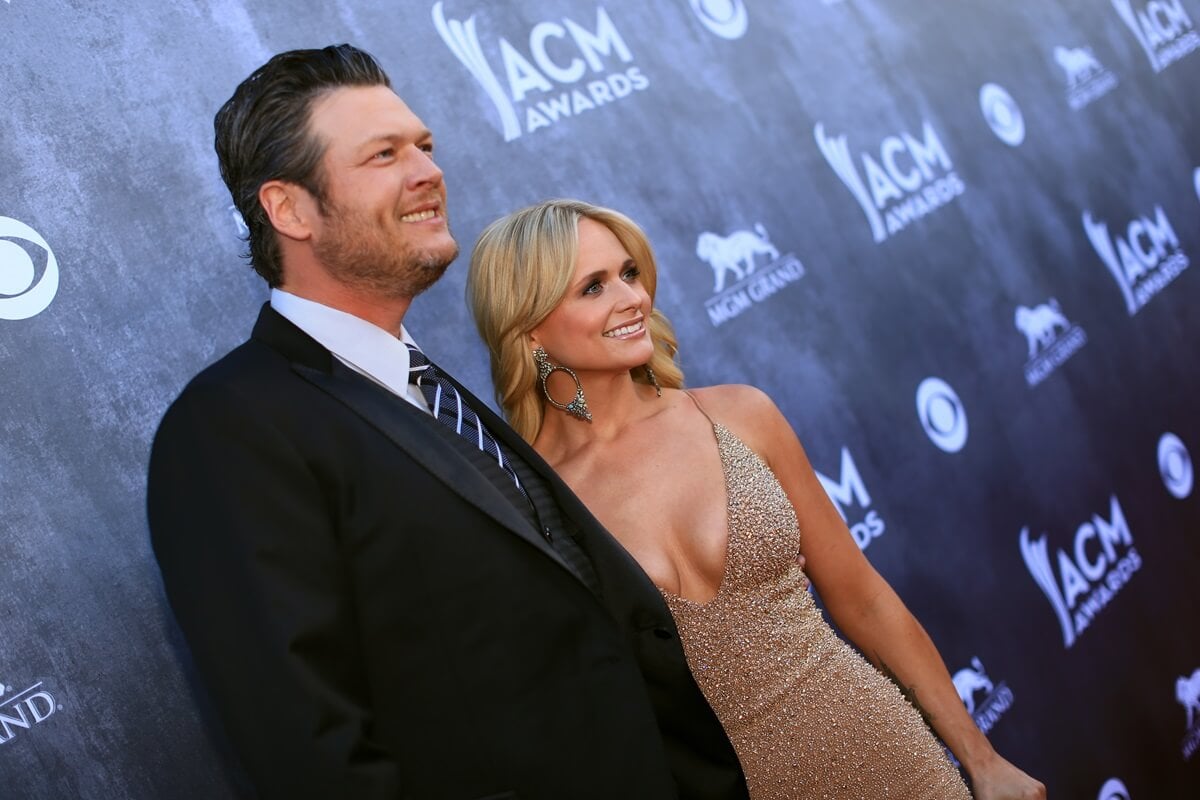 Blake Shelton (L) and Miranda Lambert attend the 49th Annual Academy of Country Music Awards in a suit and gold dress respectively.