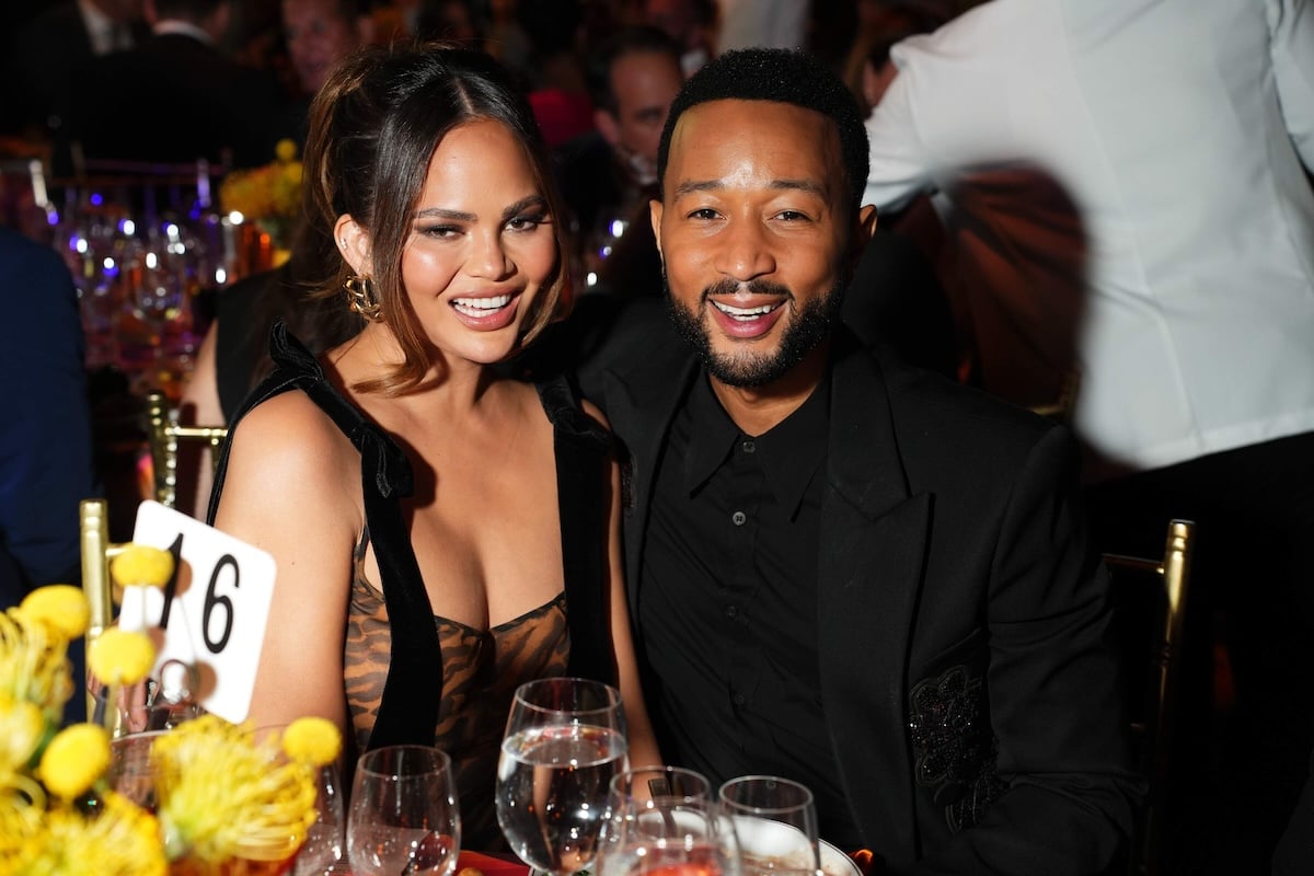 Married couple Chrissy Teigen and John Legend sit at their table at the City Harvest gala