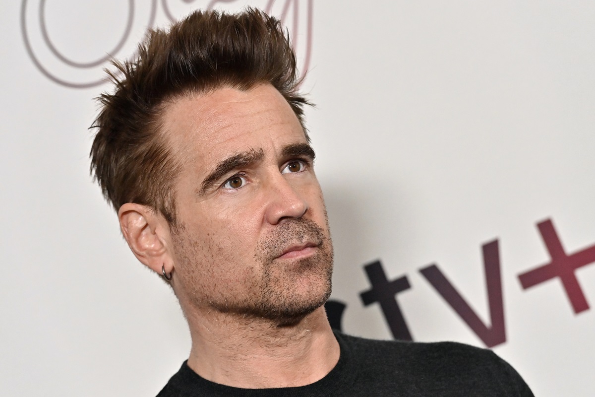 Colin Farrell posing at the premiere of 'Sugar' in a black shirt.