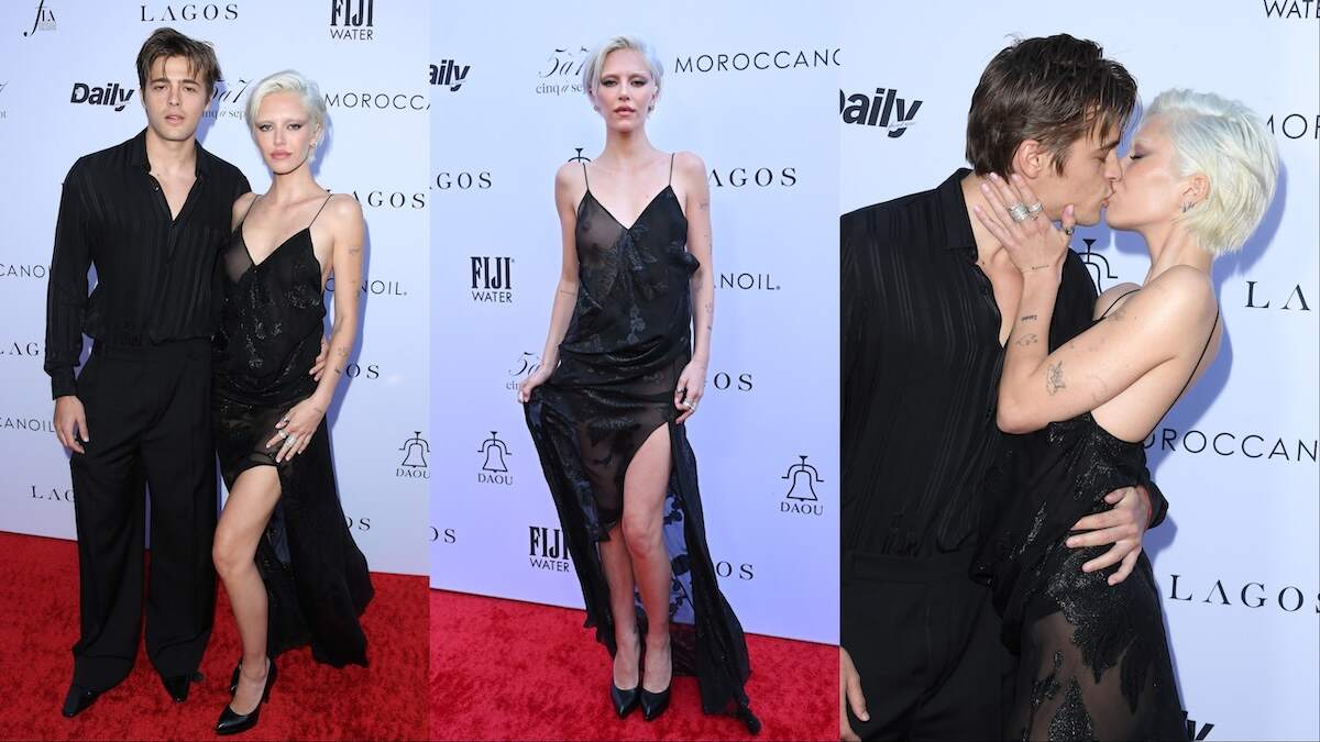 Couple Henry Eikenberry and Delilah Belle Hamlin kiss on the red carpet