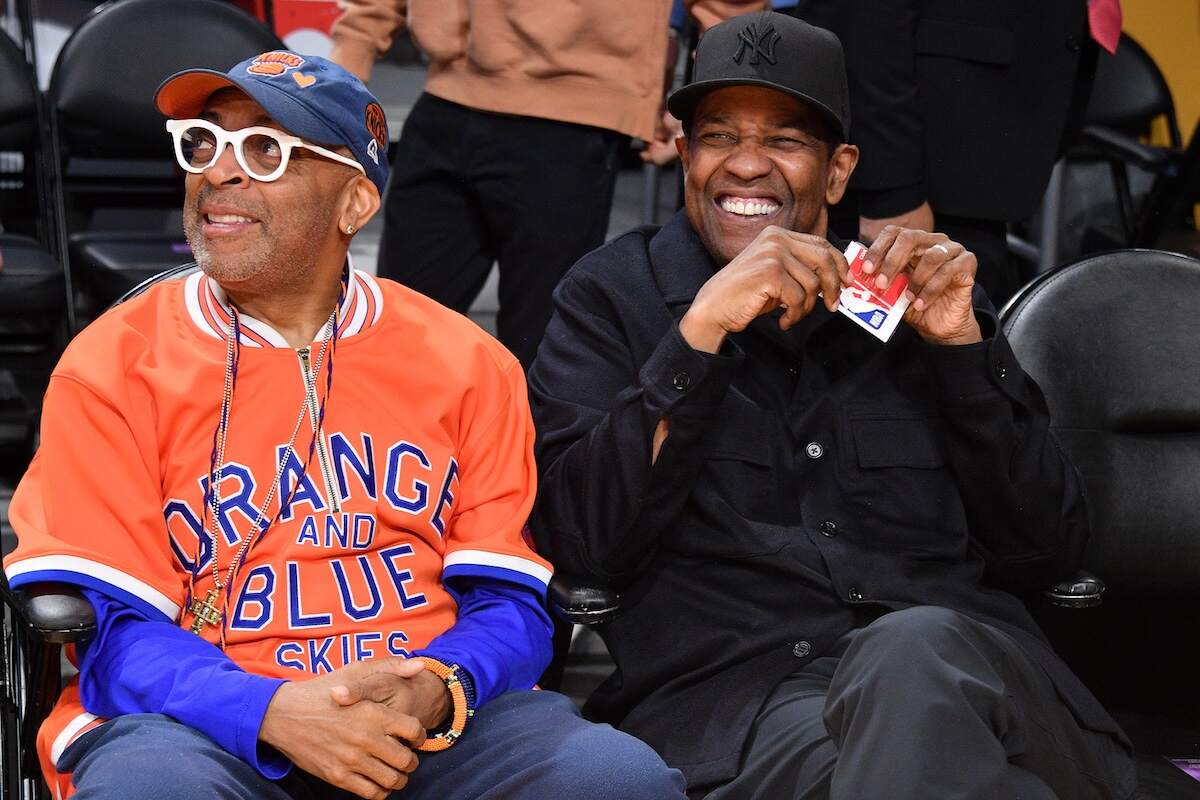Director Spike Lee and actor Denzel Washington laugh together courtside at a Lakers game
