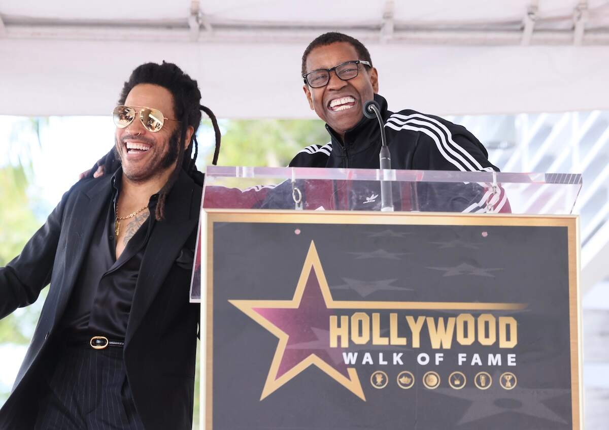 Actor Denzel Washington laughs as he speaks at the Lenny Kravitz Hollywood Walk of Fame Star Ceremony in front of a podium