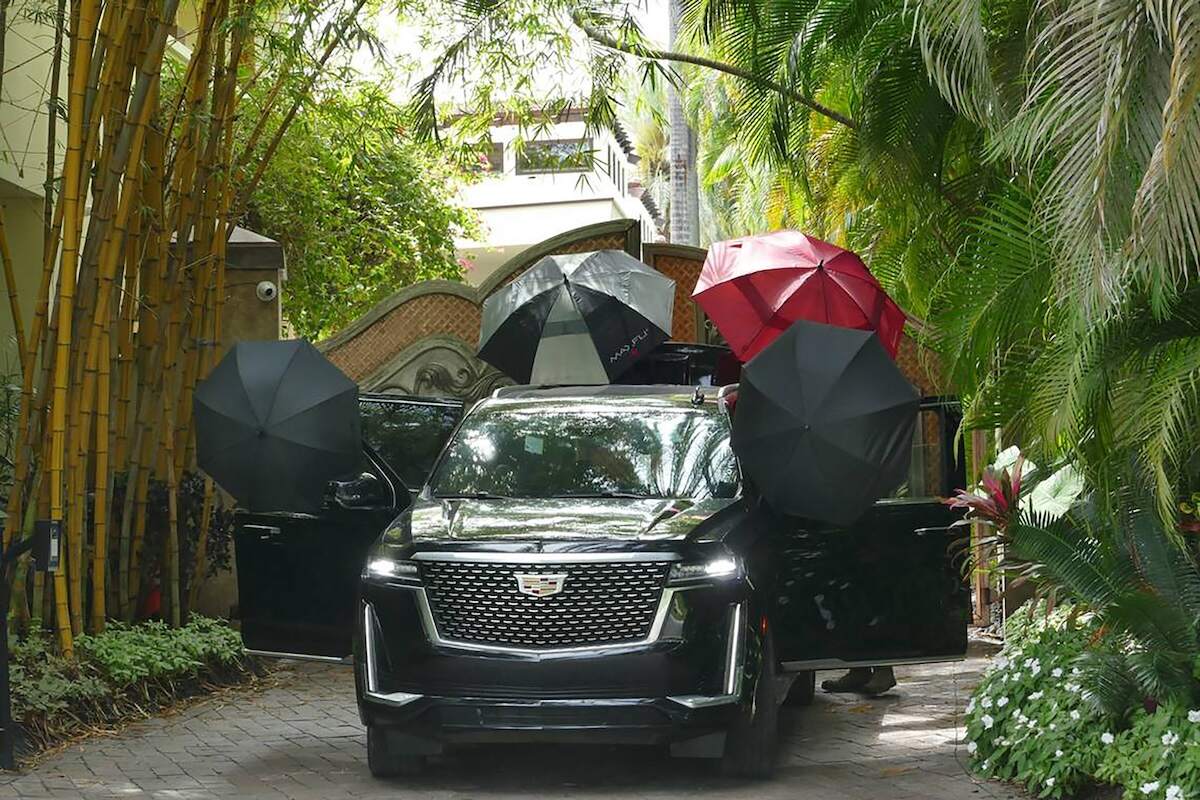 Umbrellas on a Cadillac Escalade outside Diddy's 2 Star Island Drive mansion