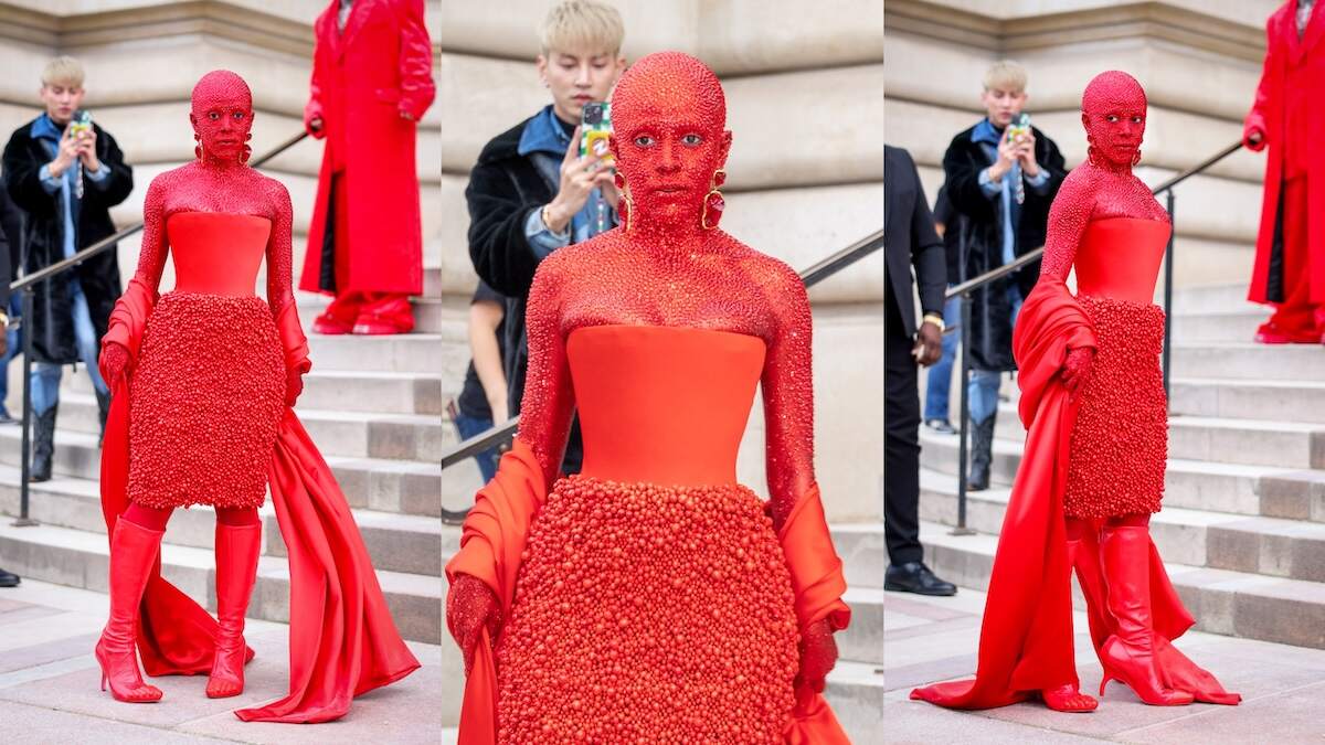 Rapper/singer Doja Cat wears a red dress while she is covered in thousands of red crystals all over her body