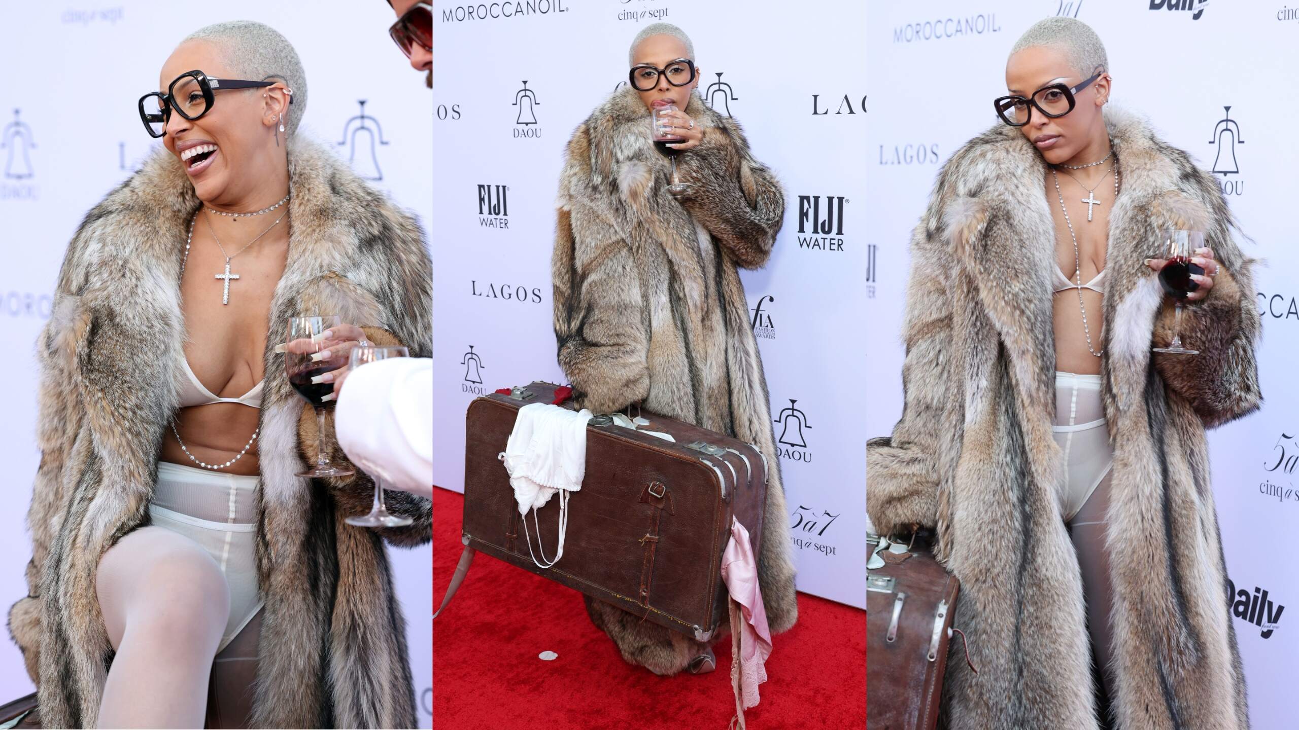Rapper/singer Doja Cat holds a glass of wine as she walks the red carpet in a fur coat at The Daily Front Row's Eighth Annual Fashion Los Angeles Awards