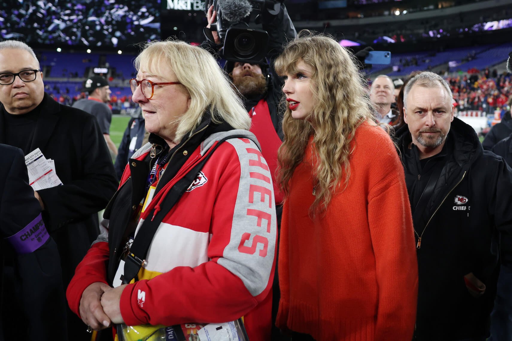 Taylor Swift walking behind Donna Kelce after a Kansas City Chiefs game