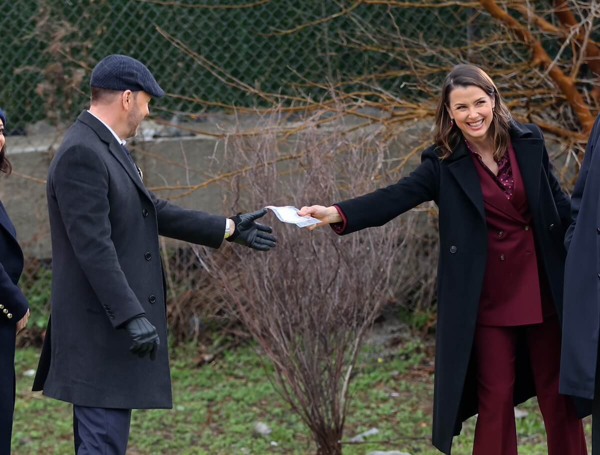 Donnie Wahlberg and Bridget Moynahan hold hands as they film an episode of 'Blue Bloods' Season 14 in New York City